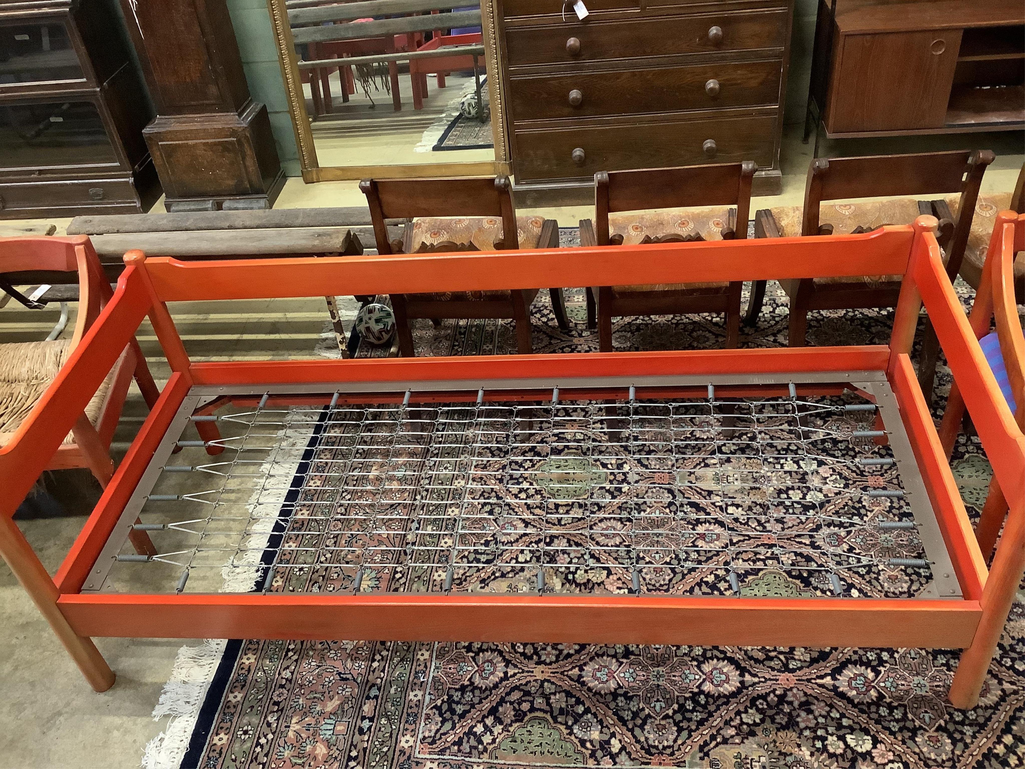 An early Habitat Magistretti style red stained beech settee, width 198cm, depth 84cm, height 69cm and a matching elbow chair. Condition - poor to fair